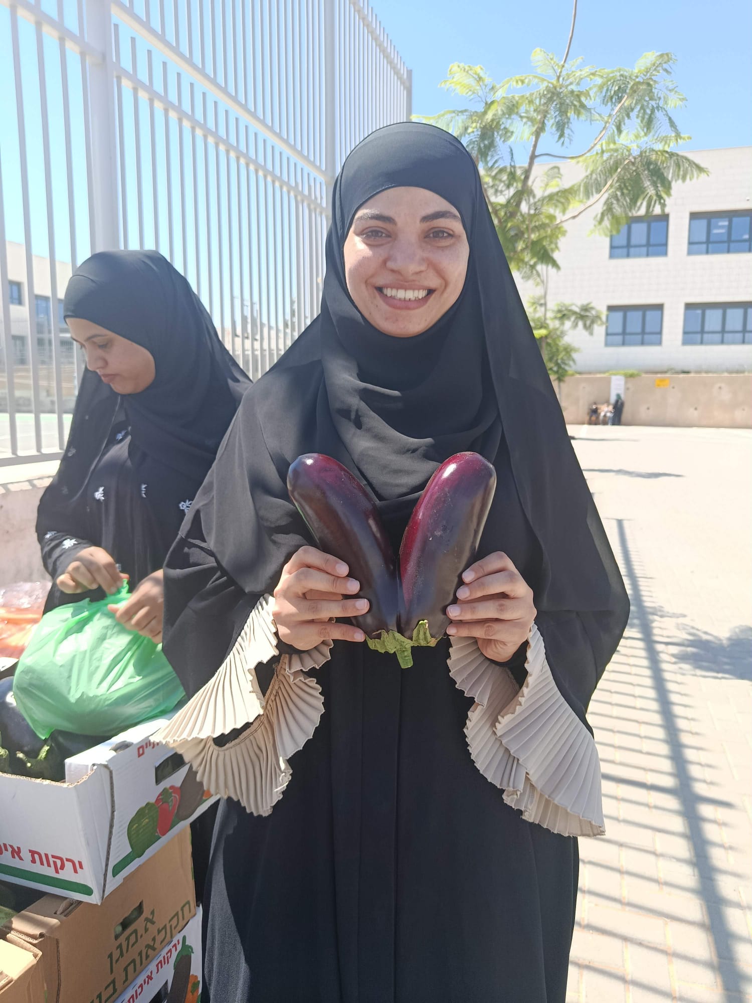 Participant holding two eggplants during a food rescue activity